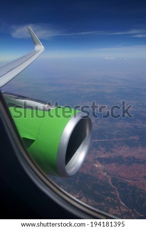 View from airplane window with blue sky and white clouds with room for text
