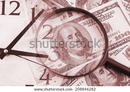 Business concept, magnifying glass on dollars background and clock