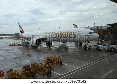 KUALA LUMPUR INTERNATIONAL AIRPORT - DECEMBER 17, 2014: Ground crew prepares Emirates Airlines plane for the next flight, December 17, 2014 in KLIA, Malaysia.