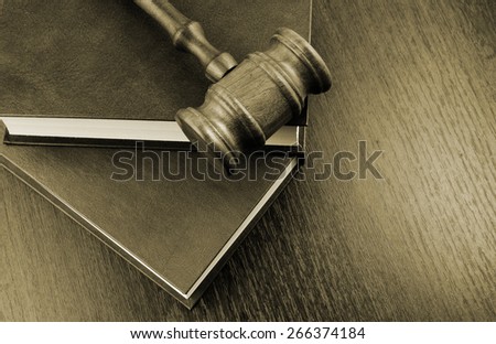 Judge\'s gavel and legal books on wooden table