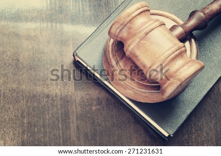 Gavel and legal book on wooden table