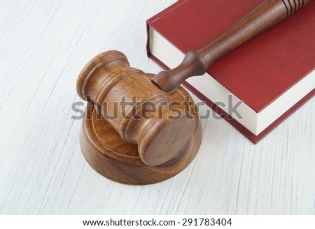 Judge gavel on red legal book, court concept