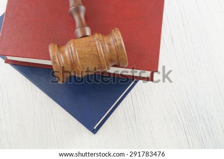 Judge gavel and legal books on wooden table