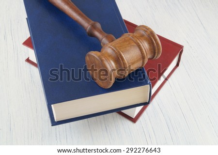 Judge gavel and legal books on wooden table
