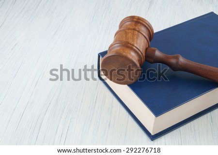Judge wooden gavel and legal book on white table with space for text