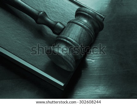 Judge gavel and legal book on wooden table