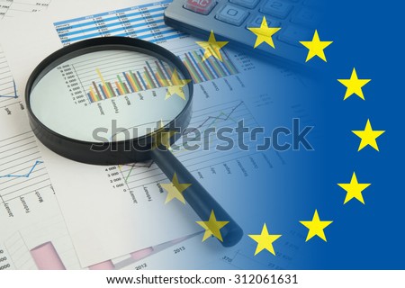 European union business concept with magnifying glass, calculators and documents