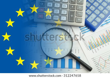 European union business concept with magnifying glass, calculators and documents