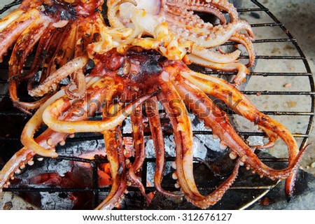 Cooking seafood barbecue, BBQ grilled squid on grid