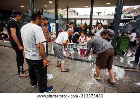 BUDAPEST - SEPTEMBER 4 : War refugees at the Keleti Railway Station on 4 September 2015 in Budapest, Hungary. Refugees are arriving constantly to Hungary on the way to Germany.