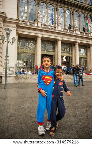 BUDAPEST - SEPTEMBER 4: War refugees children dressed superman at the Keleti Railway Station on 4 September 2015 in Budapest, Hungary. Refugees are arriving constantly to Hungary on  way to Germany.