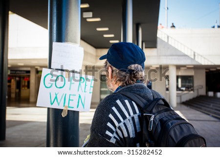 BUDAPEST - SEPTEMBER 7: war refugees reading go Wien text at Keleti Railway Station on 7 September 2015 in Budapest, Hungary. Refugees are arriving constantly to Hungary on the way to Germany.