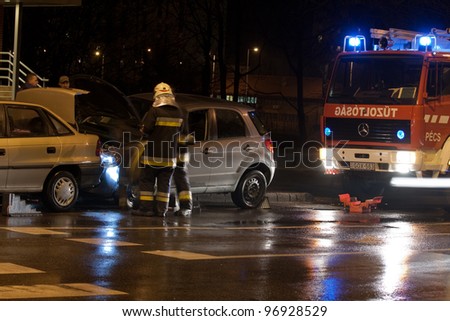 PECS, HUNGARY - DEC. 01: car crashed. Firefighter try to help the victim of car accident on Dec. 01, 2010 on Road 6 in Pecs, Hungary.
