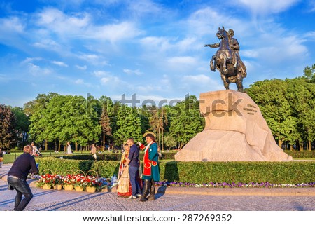 SAINT-PETERSBURG, RUSSIA - MAY 29, 2015: People in period costumes are photographed near the Bronze Horseman in Saint-Petersburg, Russia