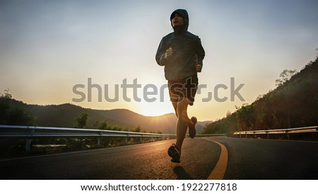 Similar – Foto Bild Sportler laufen auf Asphaltstrasse in den Bergen