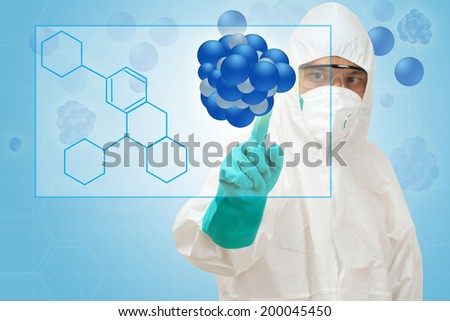 scientist in safety suit pointing to pile of molecular