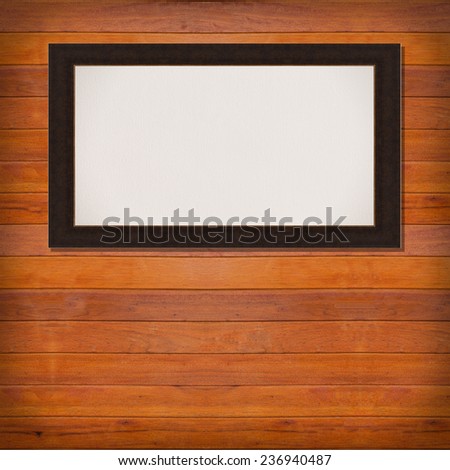 brown frame with canvas on wooden plank background