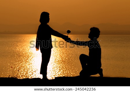 Silhouette of couple in love,Love sensuality and valentine day concept at lake side