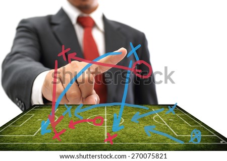 soccer manager pointing to strategy tactical board