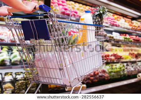 woman shopping cart in supermarket