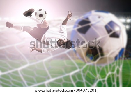 soccer player shoot over head kick on stadium light