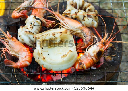Seafood barbecue of grilled Shrimps and squid on charcoal oven
