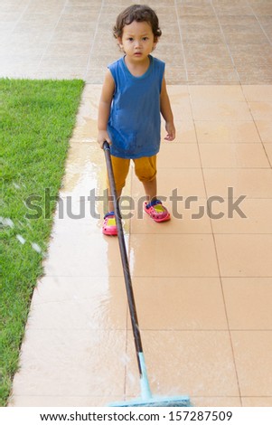 Little boy mopping the floor