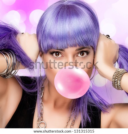 Portrait of stylish party girl with purple wig and bubble gum