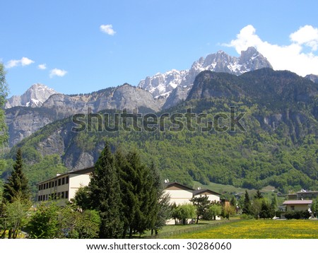 Small condominium in front of mountains in spring