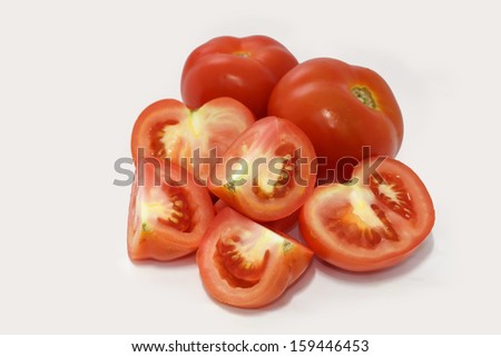 Fresh tomatoes and slices isolated on white background.