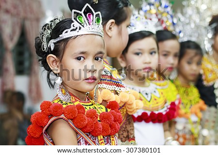 KAPIT, MALAYSIA: MAY 31, 2012: A young girl from the Iban tribe, an indigenous native people of Borneo wear a traditonal custome dress during the Gawai festival.