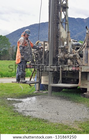 Man drilling a new water bore, Westland, New Zealand