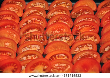 background of wedges of fresh tomato set out in rows