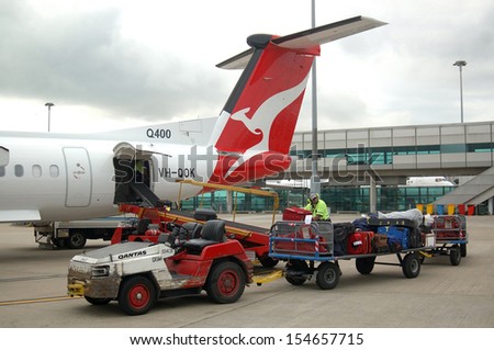 BRISBANE, AUSTRALIA, September 24, 2008: Baggage handlers load aircraft at Brisbane Domestic Airpport Terminal on September 24, 2008 in Brisbane, Australia