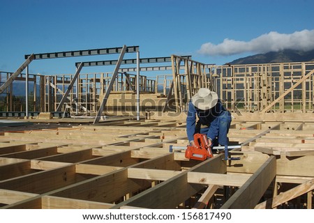 Builder uses a nail gun on flooring job