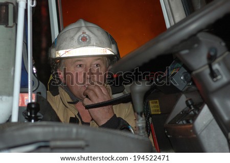 GREYMOUTH, NEW ZEALAND,  CIRCA 2006: Fire chief calls on radio  from fire engine to enlist help in fighting a bushfire, Westland, New Zealand