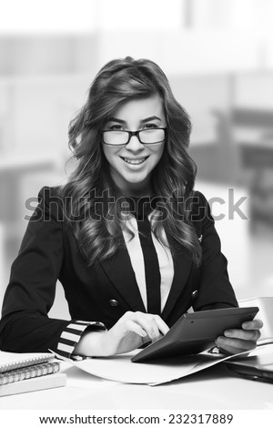 Young woman secretary at work at the office