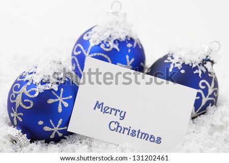 Christmas Ornament on snowy background with Merry Christmas
