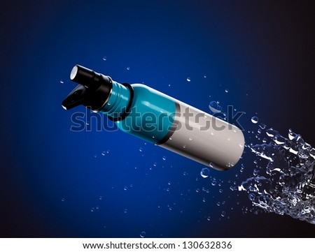 Blue steel bottle shooting through splashing water.