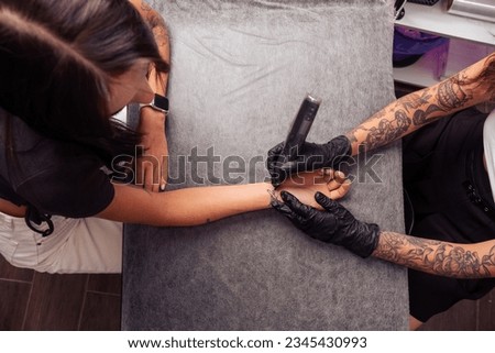 Image, Stock Photo Anonymous crop tattooist working with client in salon