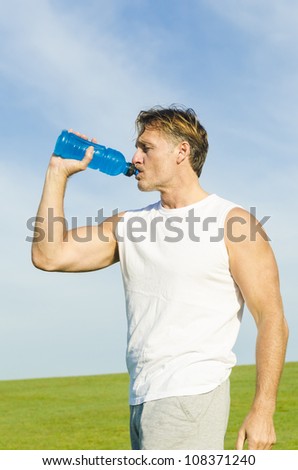 A sportsman drinking from his water bottle.