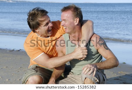 stock-photo-a-happy-gay-couple-having-fun-on-the-beach-15285382.jpg