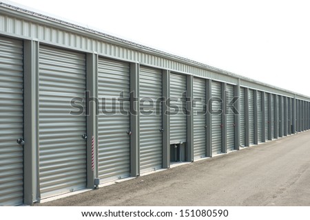 Storage units at a storage facility with one door partially open.