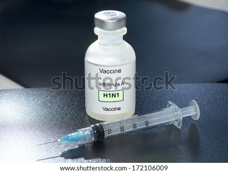 H1N1 Influenza vaccine and syringe.