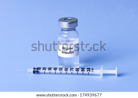 Regular insulin with insulin syringe on light blue background.  Label is not real.