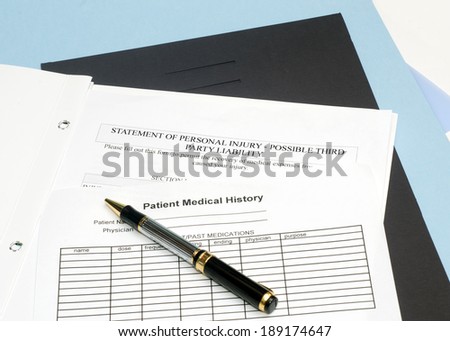 Statement of personal injury form with patient chart and pen.