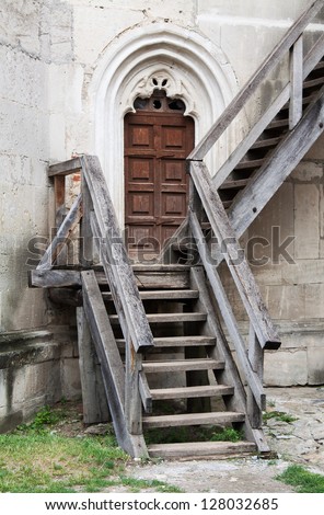 Old entrance to the fortress with wooden stairs and doors