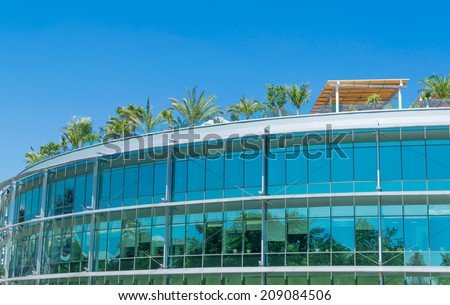 Building with a glass facade and green roof garden