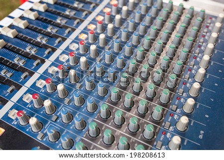 Detail of a music mixer in studio, dj working for a new song