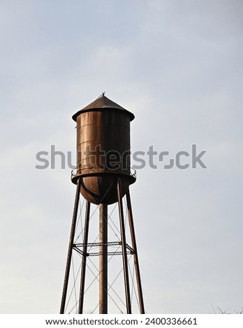 Similar – Image, Stock Photo Vintage water tank on high rusty iron frame in front of grey clouds